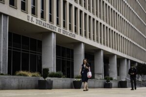 Woman walking past federal building
