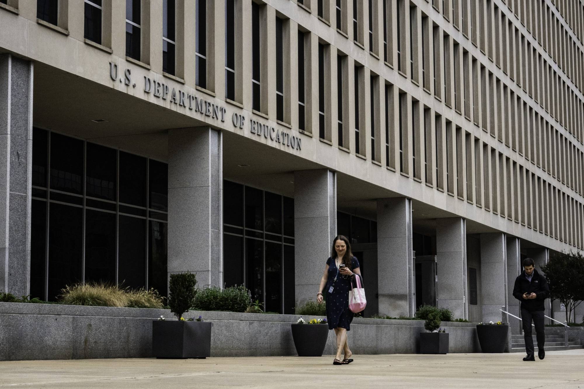 Woman walking past federal building