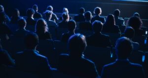 Rear view of audience in a darkened room